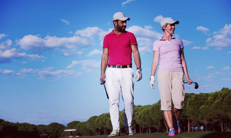 couple-walking-on-golf-course-1200-web